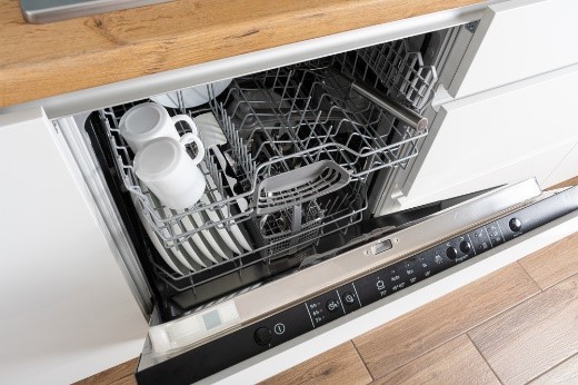 Fully integrated dishwasher in a modern kitchen with matching cabinetry front panel.